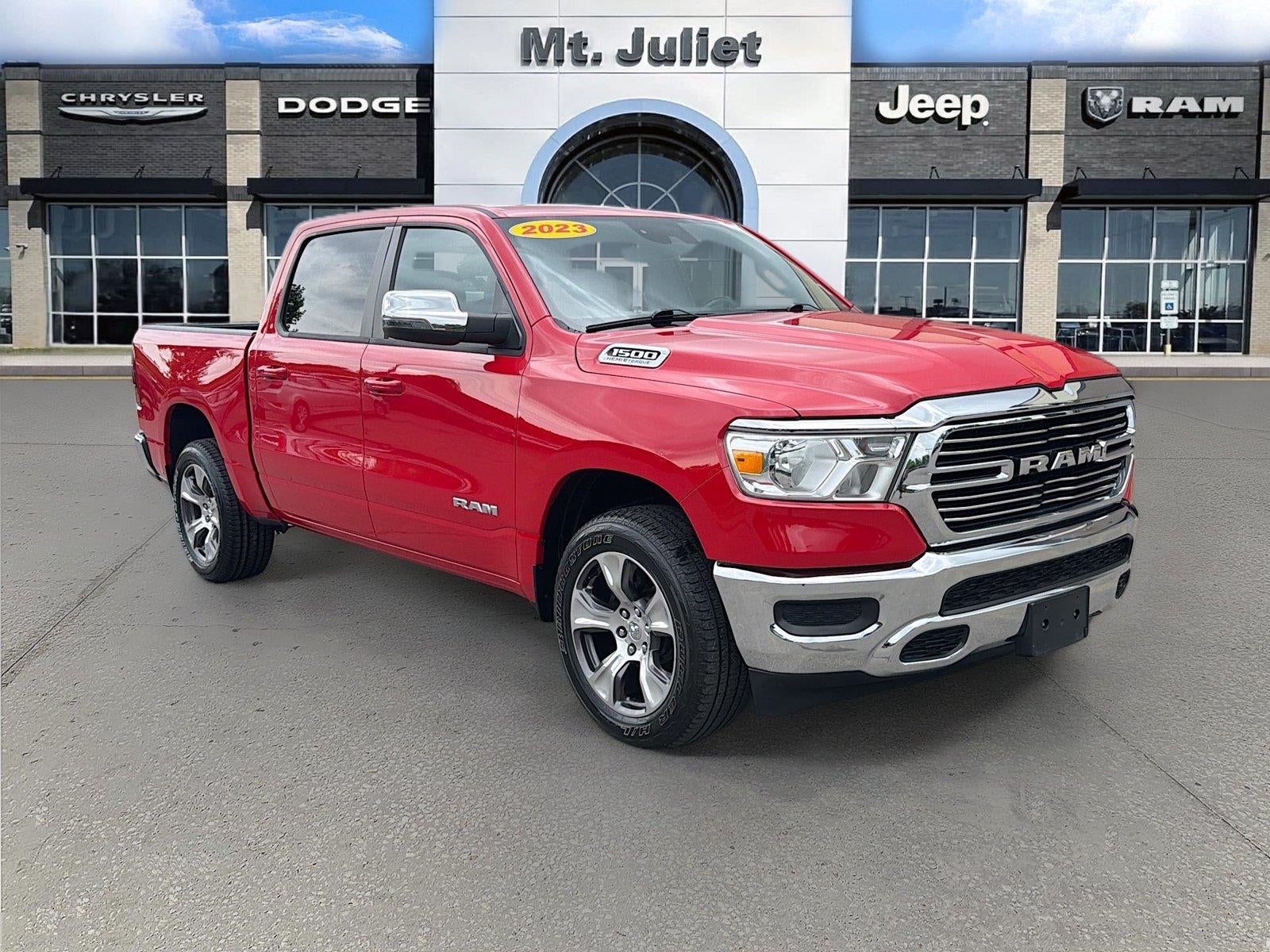 2023 RAM 1500 Laramie Crew Cab 4x4 5'7' Box in Flame Red Clearcoat — front three-quarter view