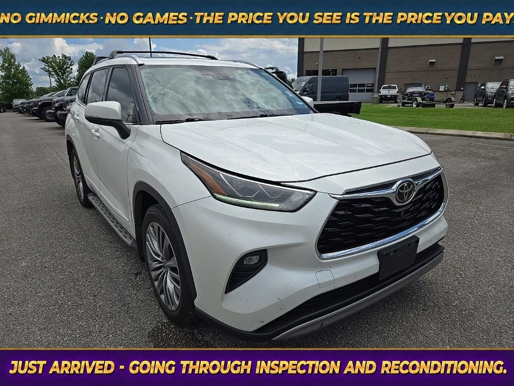 2021 Toyota Highlander Platinum in Blizzard Pearl — front three-quarter view